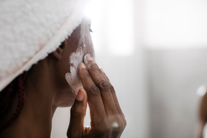 woman gently cleansing her skin