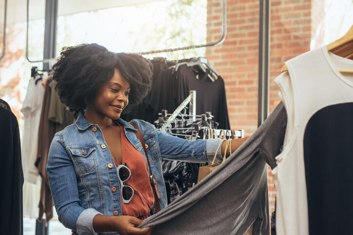 woman checking the fabric of clothing