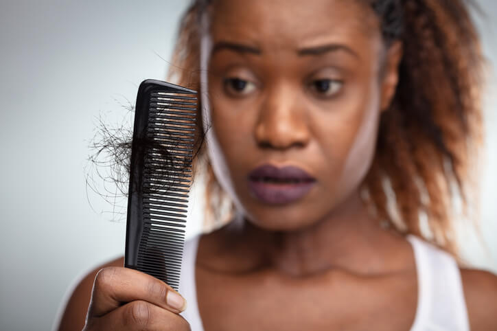 woman experiencing hair shedding