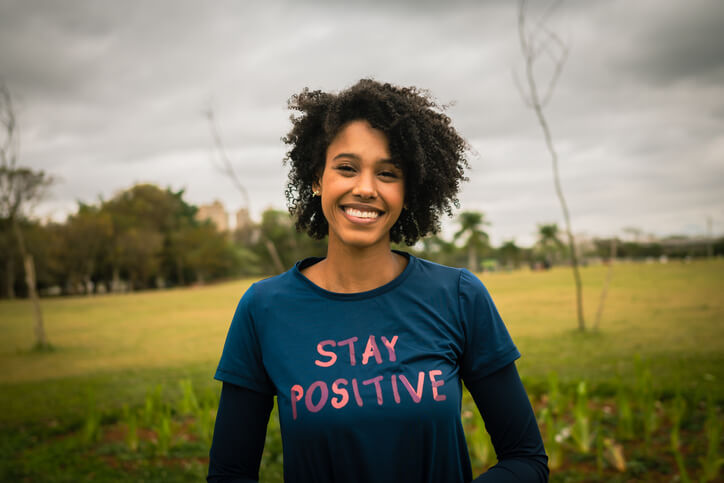 woman smiling in joy practicing wellness activies